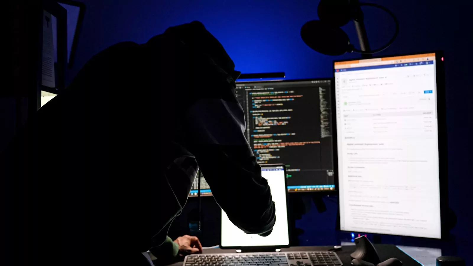 a man sitting in front of a computer monitor